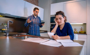Desperate young couple with debts reviewing their bills